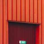 red wooden door with red wall