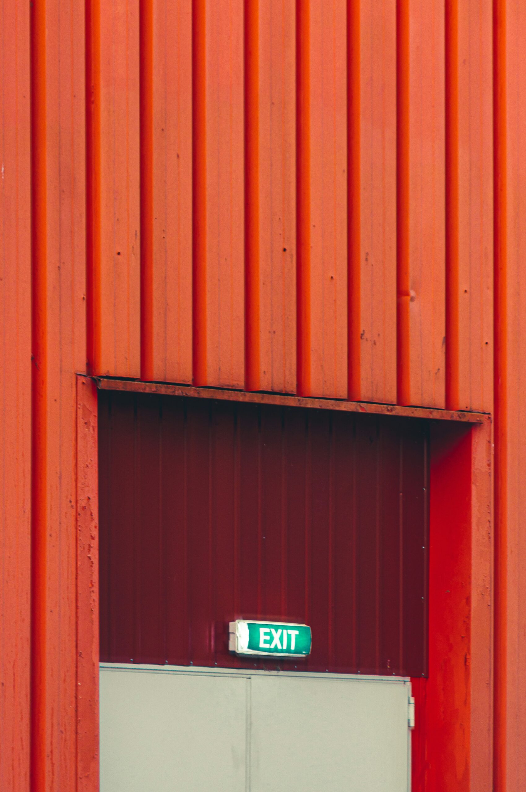 red wooden door with red wall